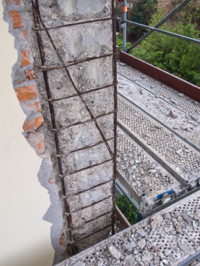 Brick facade removed showing deteriorating concrete 